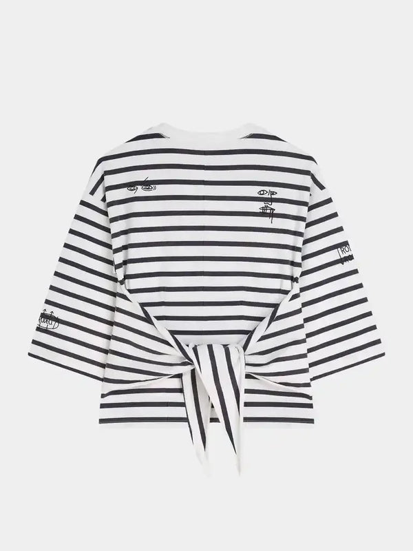 Black and white striped women's top with tie-back and graphic details