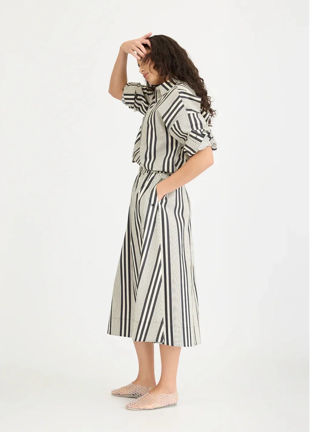 Woman in black and white striped dress and clear flats at The Tartan Fox boutique