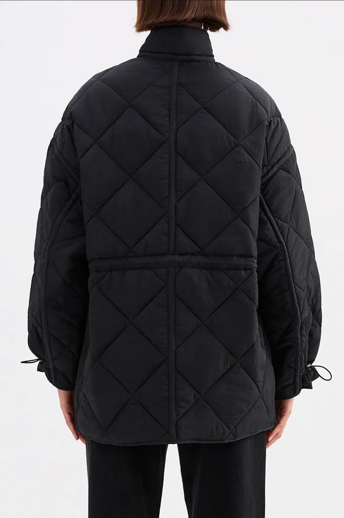Black quilted puffer jacket with diamond stitching and drawstring cuffs, back view