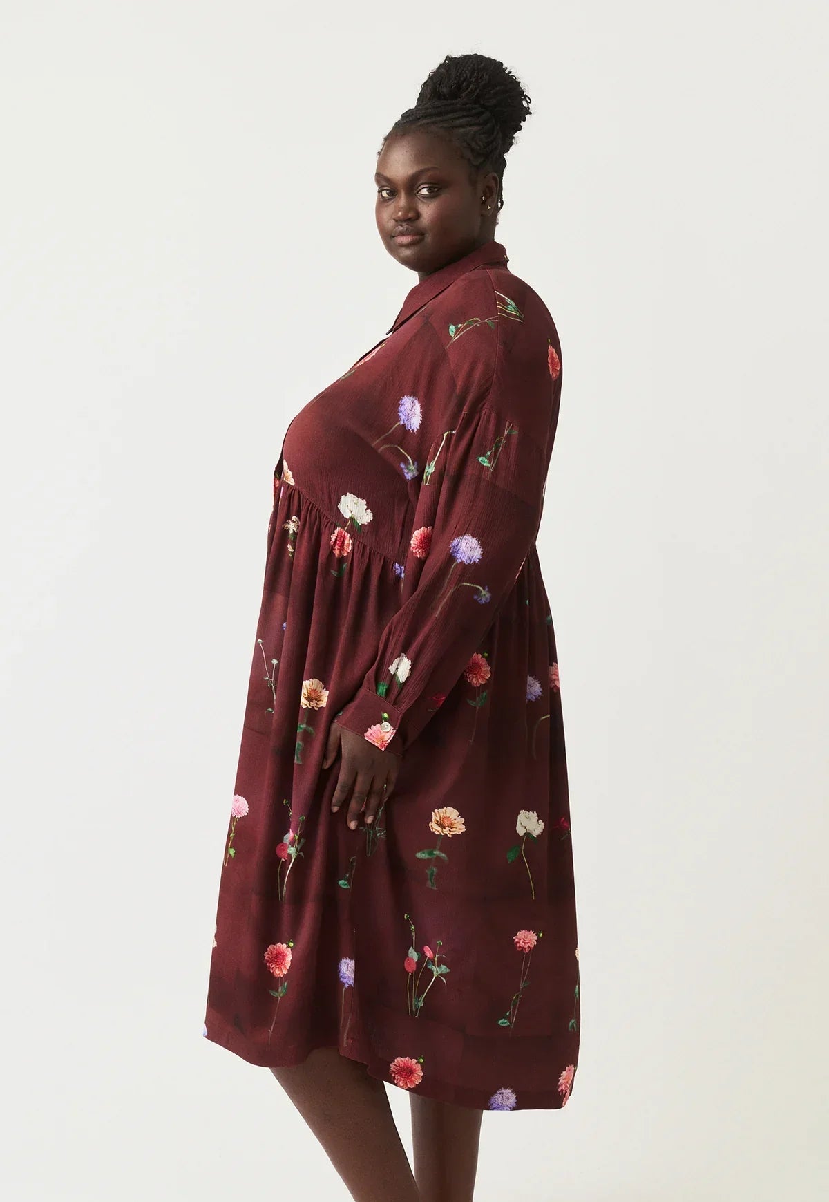 Burgundy floral print dress with long sleeves, side view