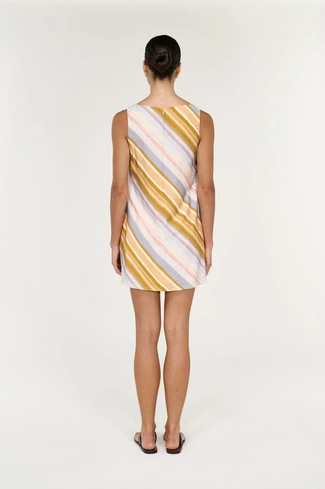 Back view of a woman wearing the STAPLE THE LABEL Veda Mini Dress in Stripe.