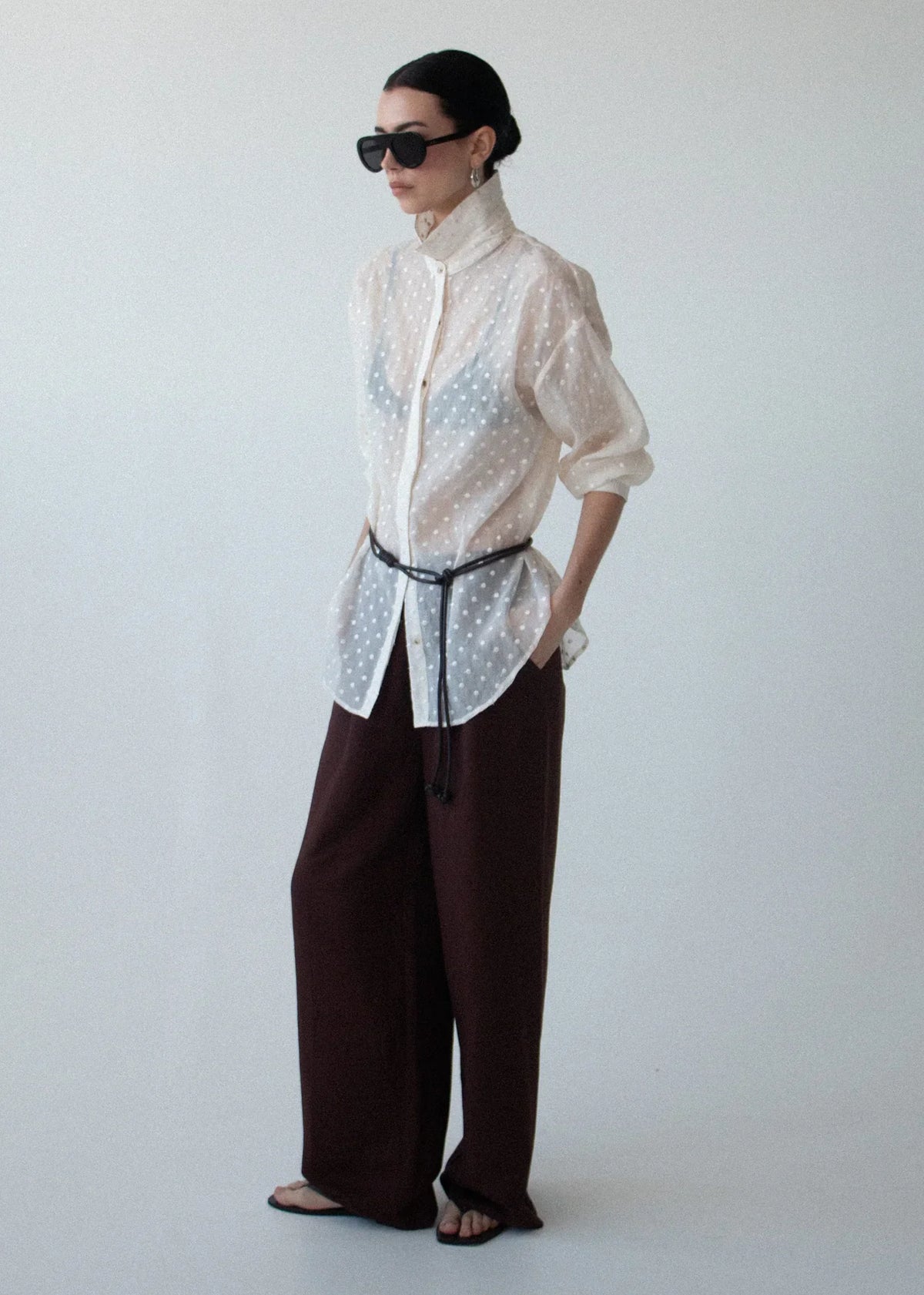 Woman wearing a STAPLE THE LABEL Etoile Oversized Shirt in Cream Spot with brown trousers.
