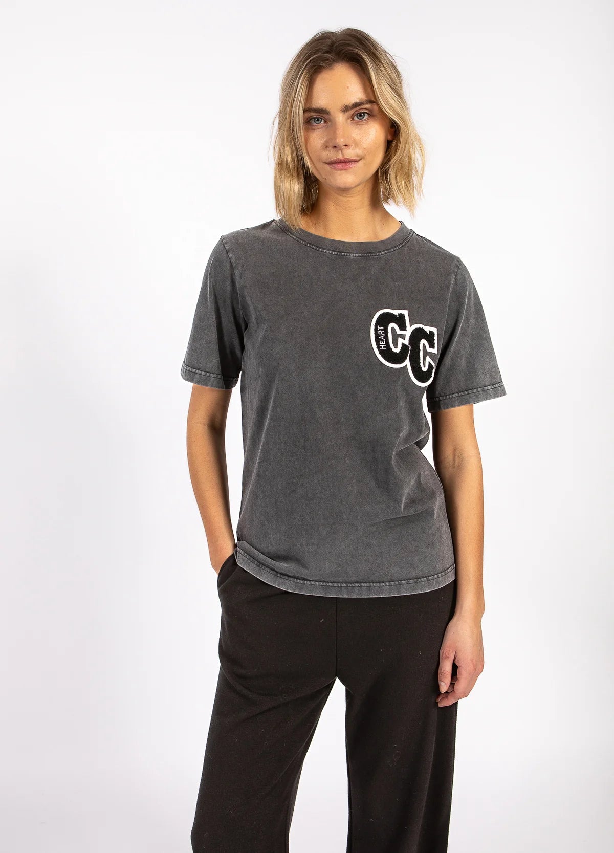 Woman wearing charcoal graphic tee and black pants, boutique fashion at The Tartan Fox