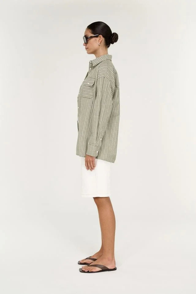 Woman wearing STAPLE THE LABEL Lisara Oversized Shirt in khaki and white stripe with white shorts