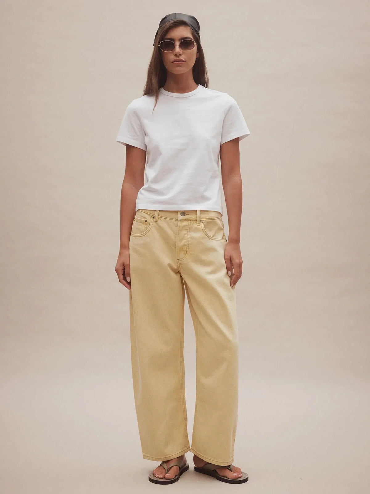 Woman wearing Nobody Denim Nadia Jean in Flax with a white t-shirt and sandals.