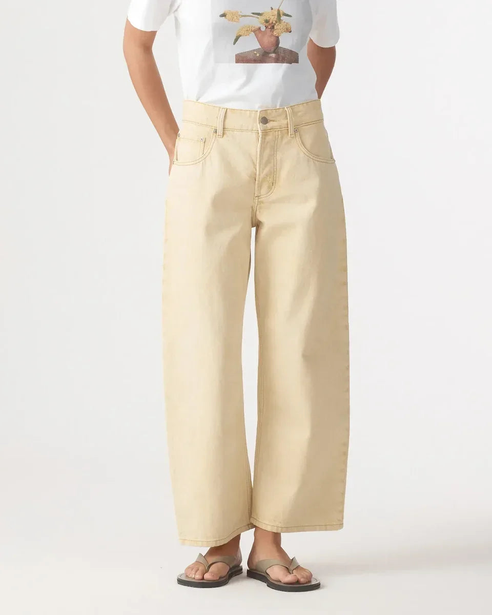 Woman wearing Nobody denim Nadia Jean in Flax wide leg pants and a white t-shirt.
