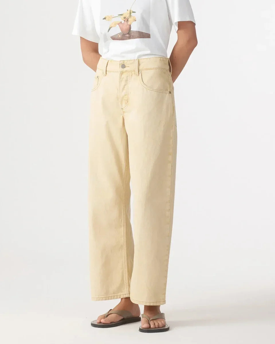 Nobody Denim Nadia Jean in Flax worn with a white t-shirt and sandals.