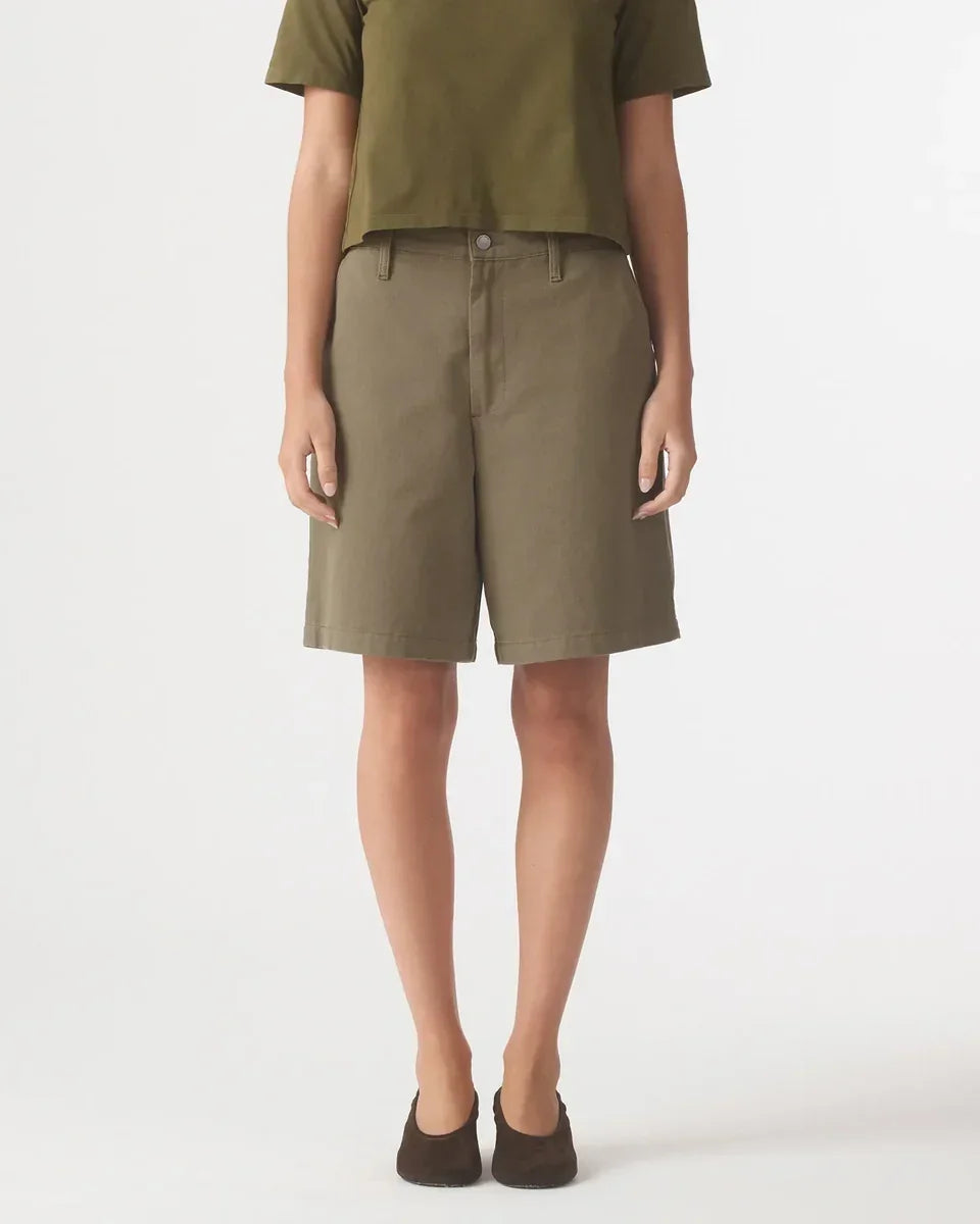 Woman wearing Nobody Denim Rowan Bermuda Shorts in Safari paired with a green t-shirt.