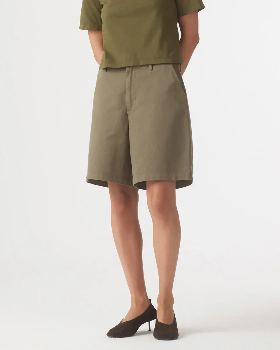 Back view of Nobody Denim Rowan Bermuda Shorts in Safari paired with brown heels.