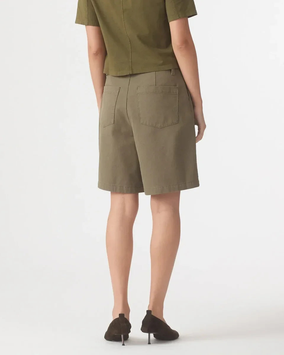 Back view of a model wearing Nobody Denim Rowan Bermuda Shorts in Safari.