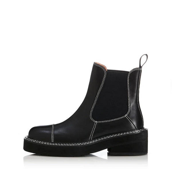 Black Chelsea boot with white stitching, chunky platform sole, and pull tab for women's fashion
