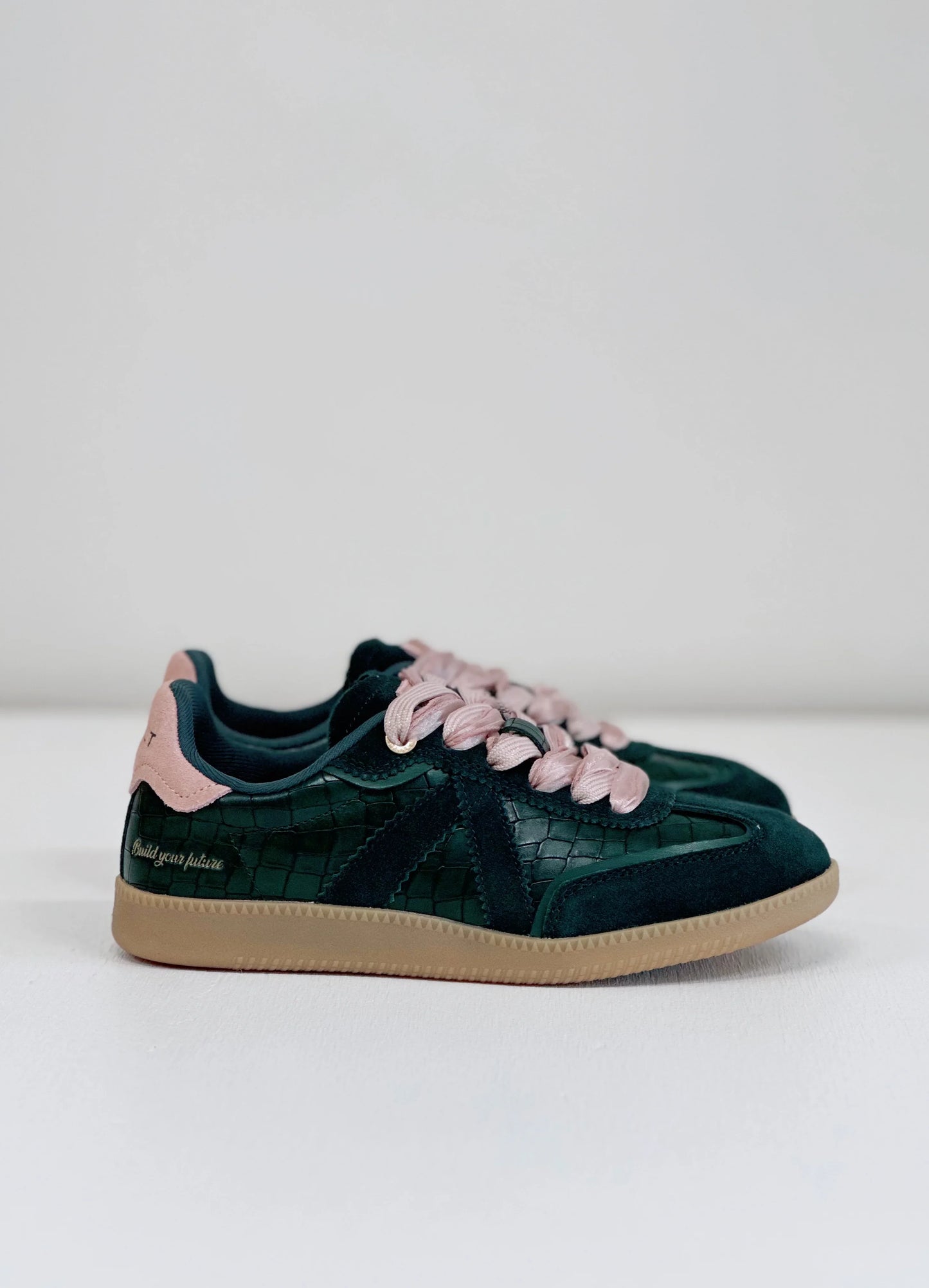 Green croc-texture sneaker with pink laces and suede accents, stylish everyday footwear