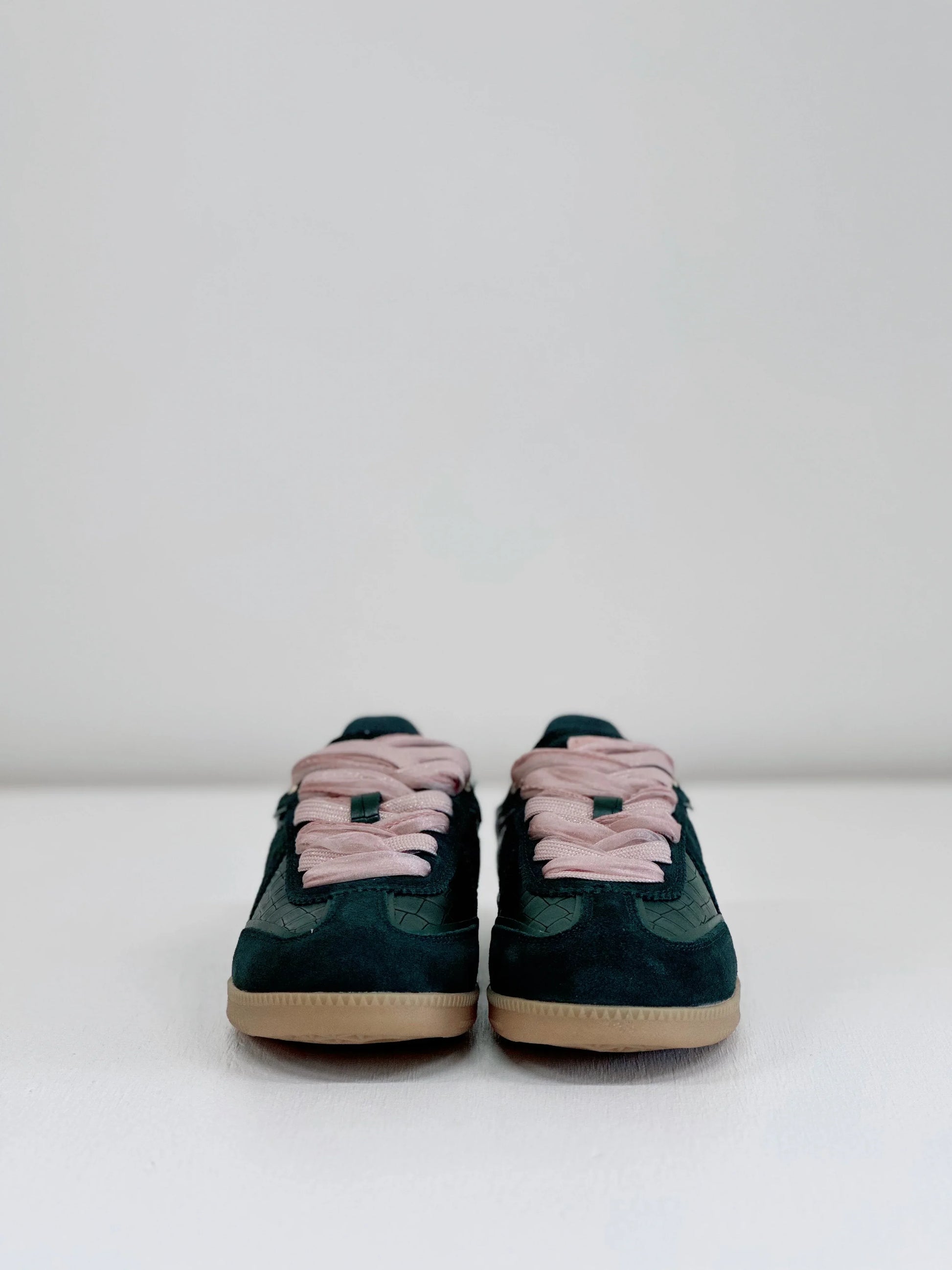 Dark green suede sneakers with pink laces and gum soles, stylish everyday footwear