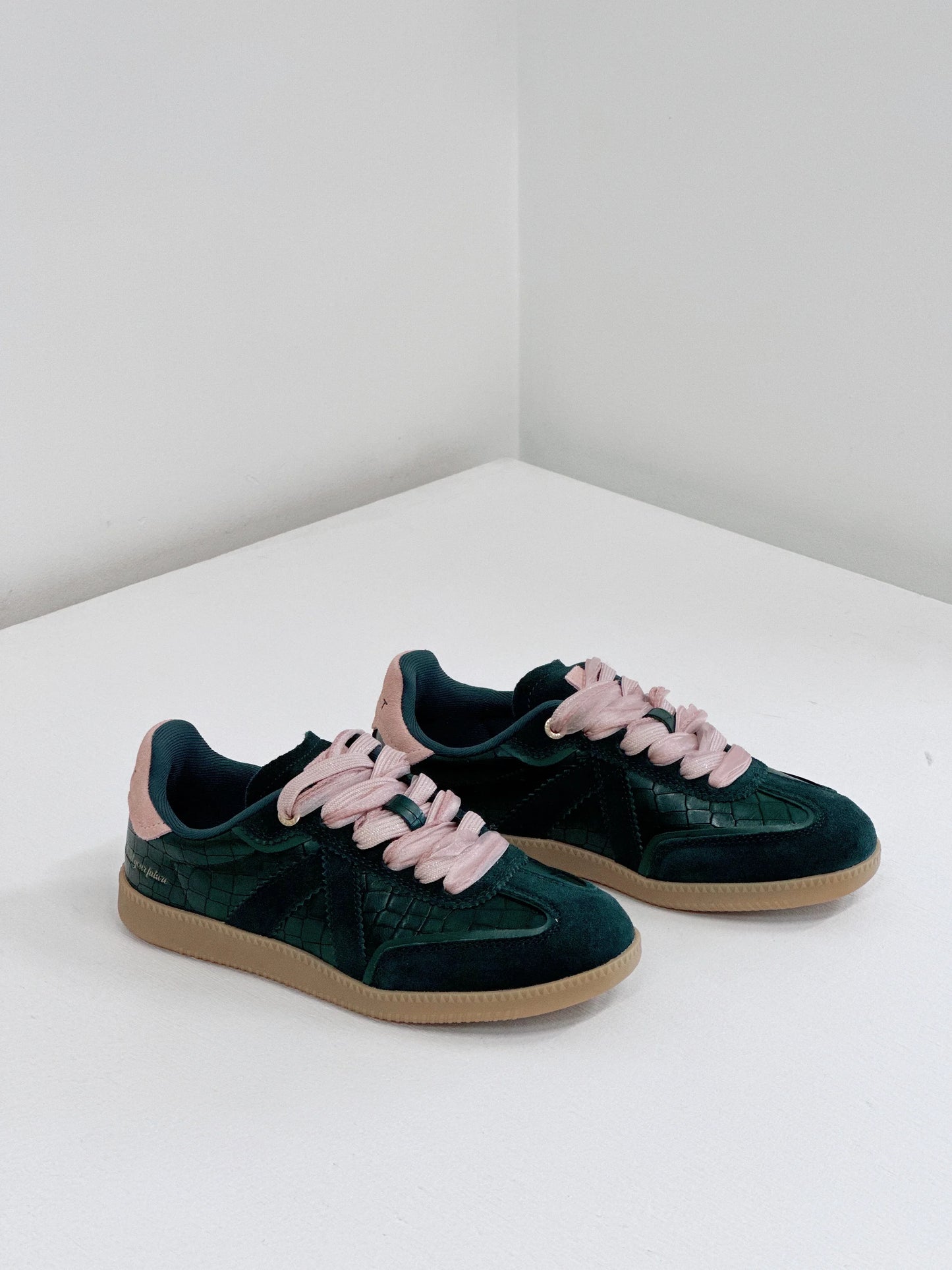Dark green suede sneakers with pink laces and croc-textured panels, stylish everyday footwear
