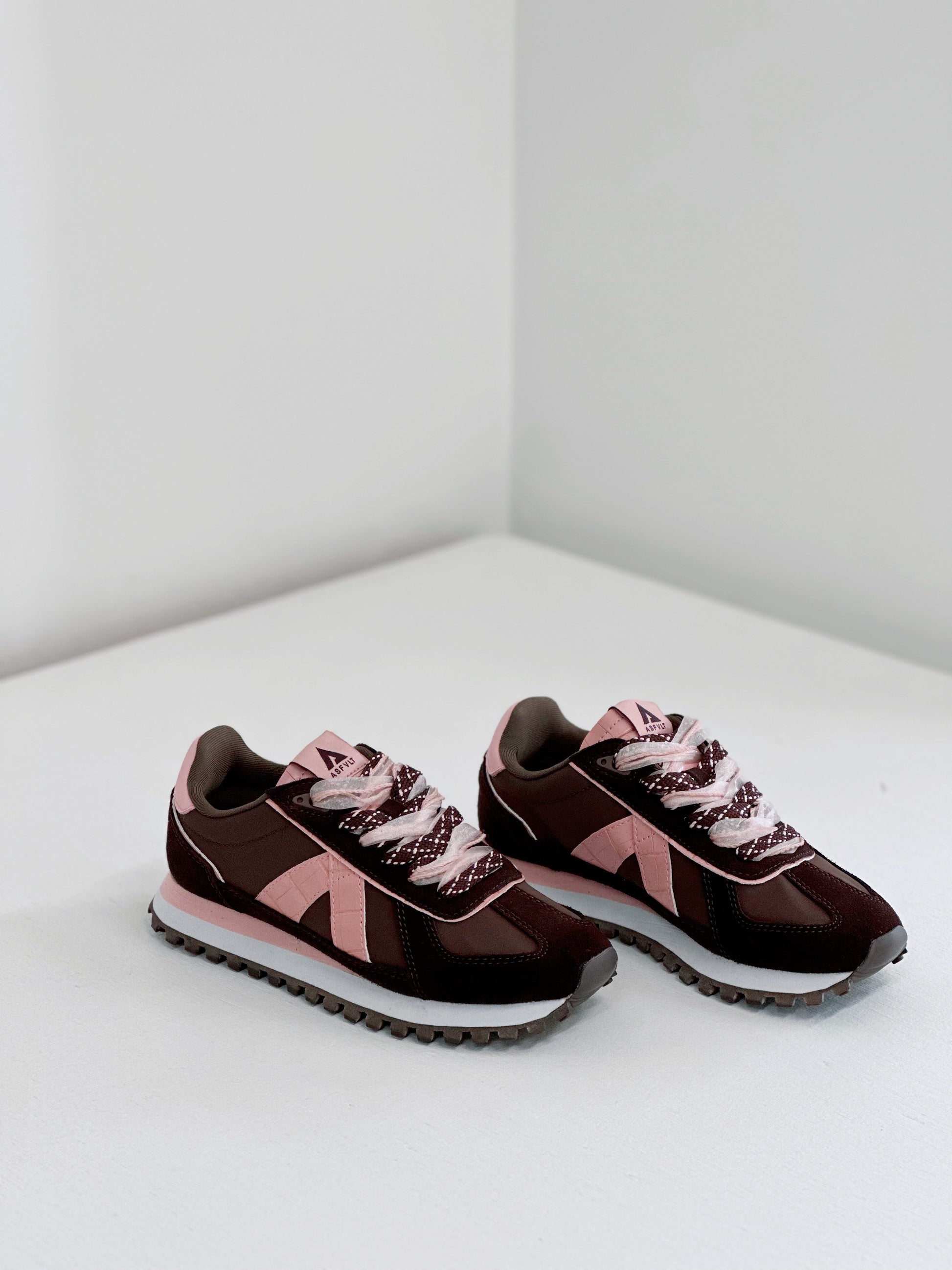 Brown and pink retro sneakers with textured laces and white soles