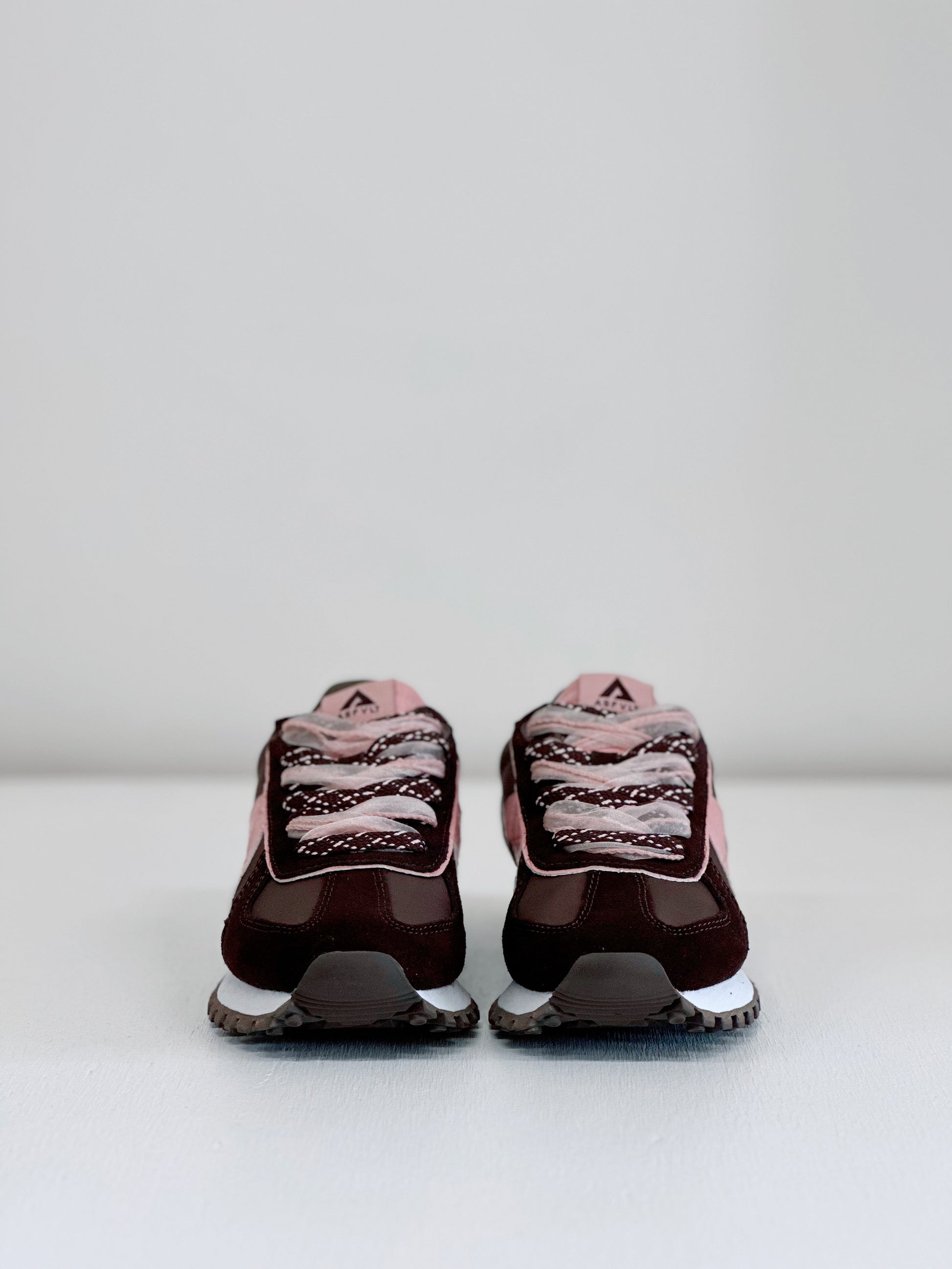 Brown and pink retro sneakers with mesh detailing and white soles