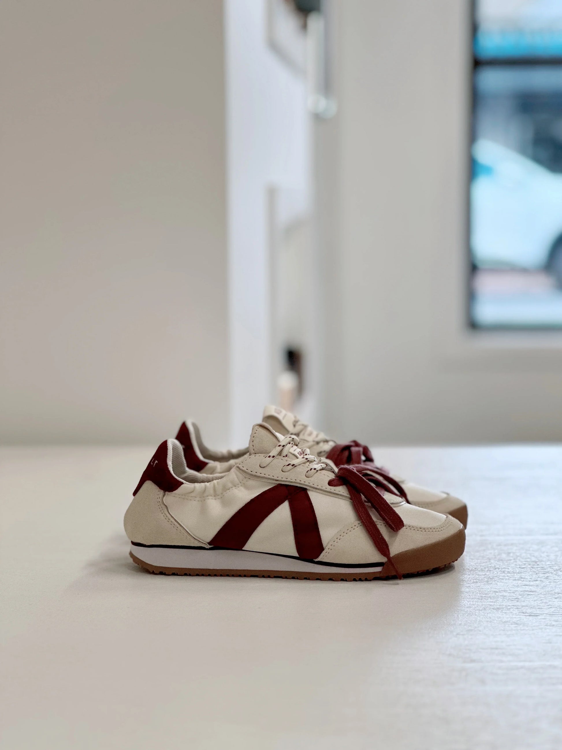 Cream and burgundy retro sneakers with bold V design, ideal for everyday stylish wear