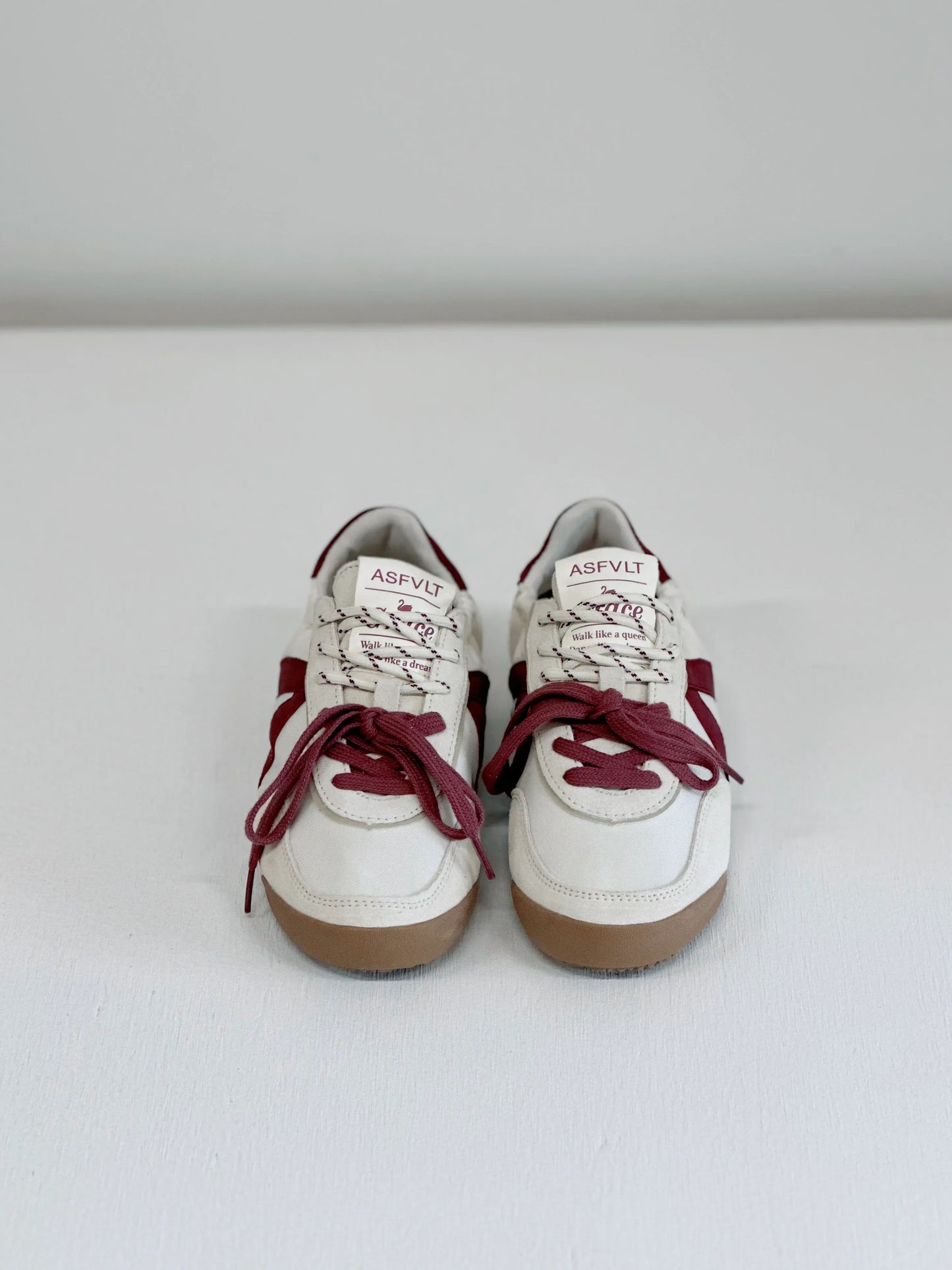 White and burgundy ASFLVT sneakers with gum soles, styled for everyday fashion and comfort.