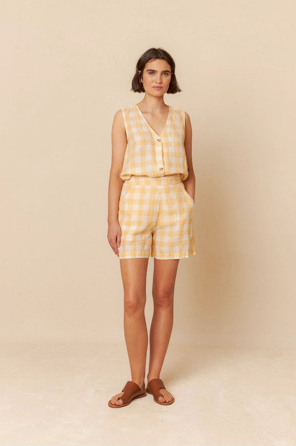 Yellow gingham sleeveless top and shorts set for women, paired with brown sandals