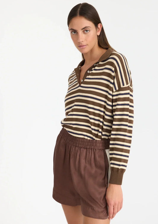 Woman wearing striped long sleeve polo top and brown shorts, women's fashion