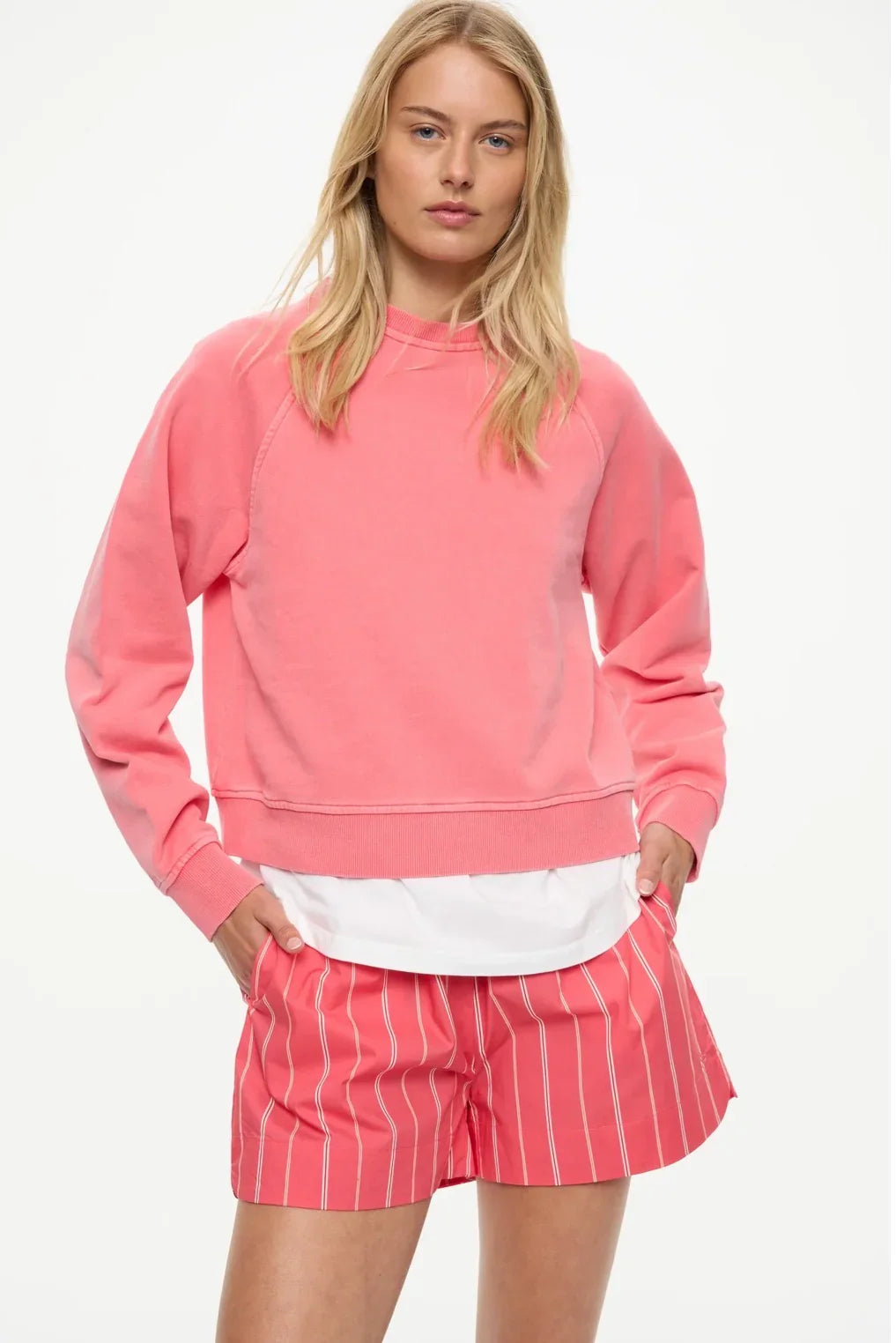 Pink sweatshirt and striped shorts women's fashion outfit