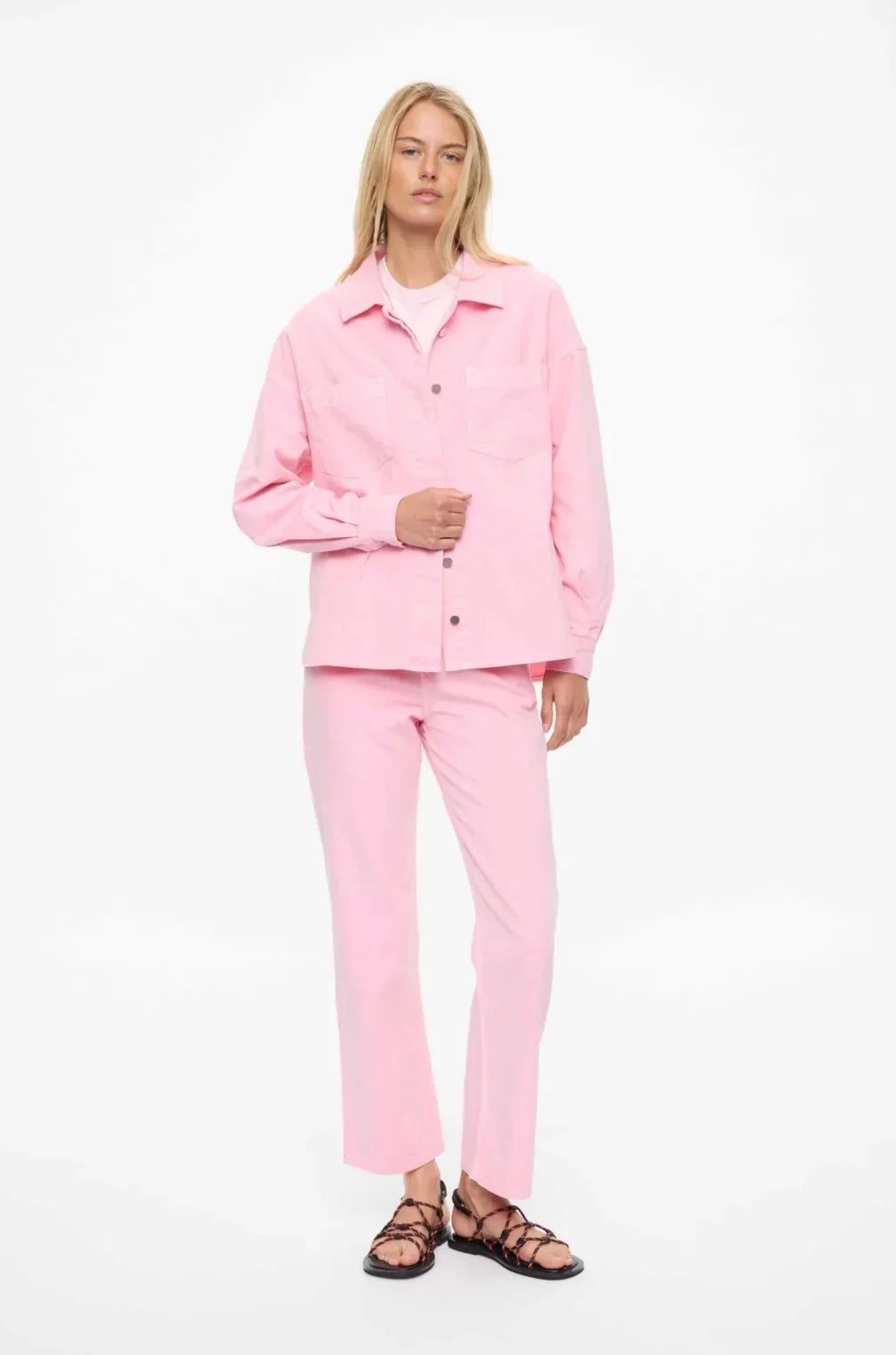 Pink women's fashion shirt and pants set with strappy sandals