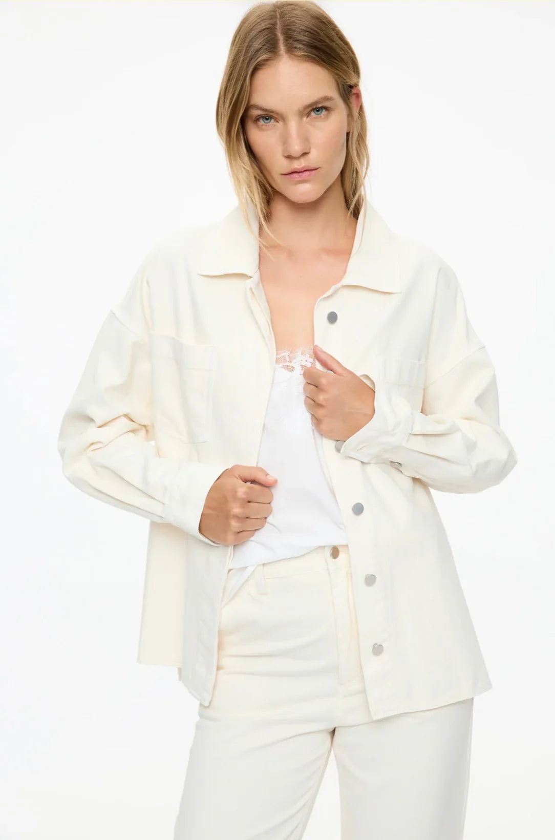 Cream oversized shirt jacket with button front, paired with matching pants and lace top for women's fashion