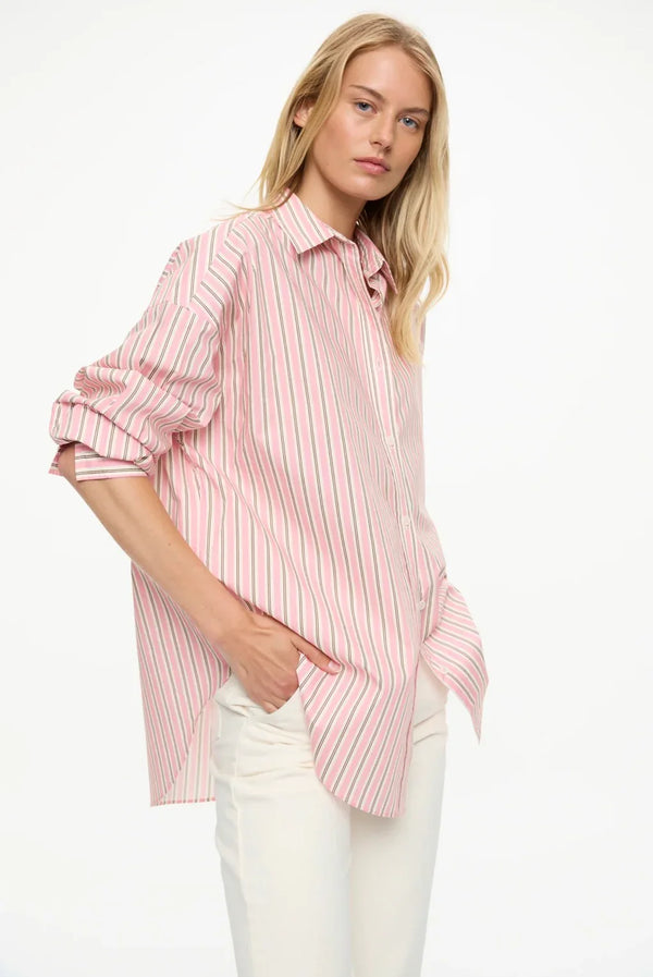 Pink striped oversized shirt with rolled sleeves, paired with white pants for women's fashion