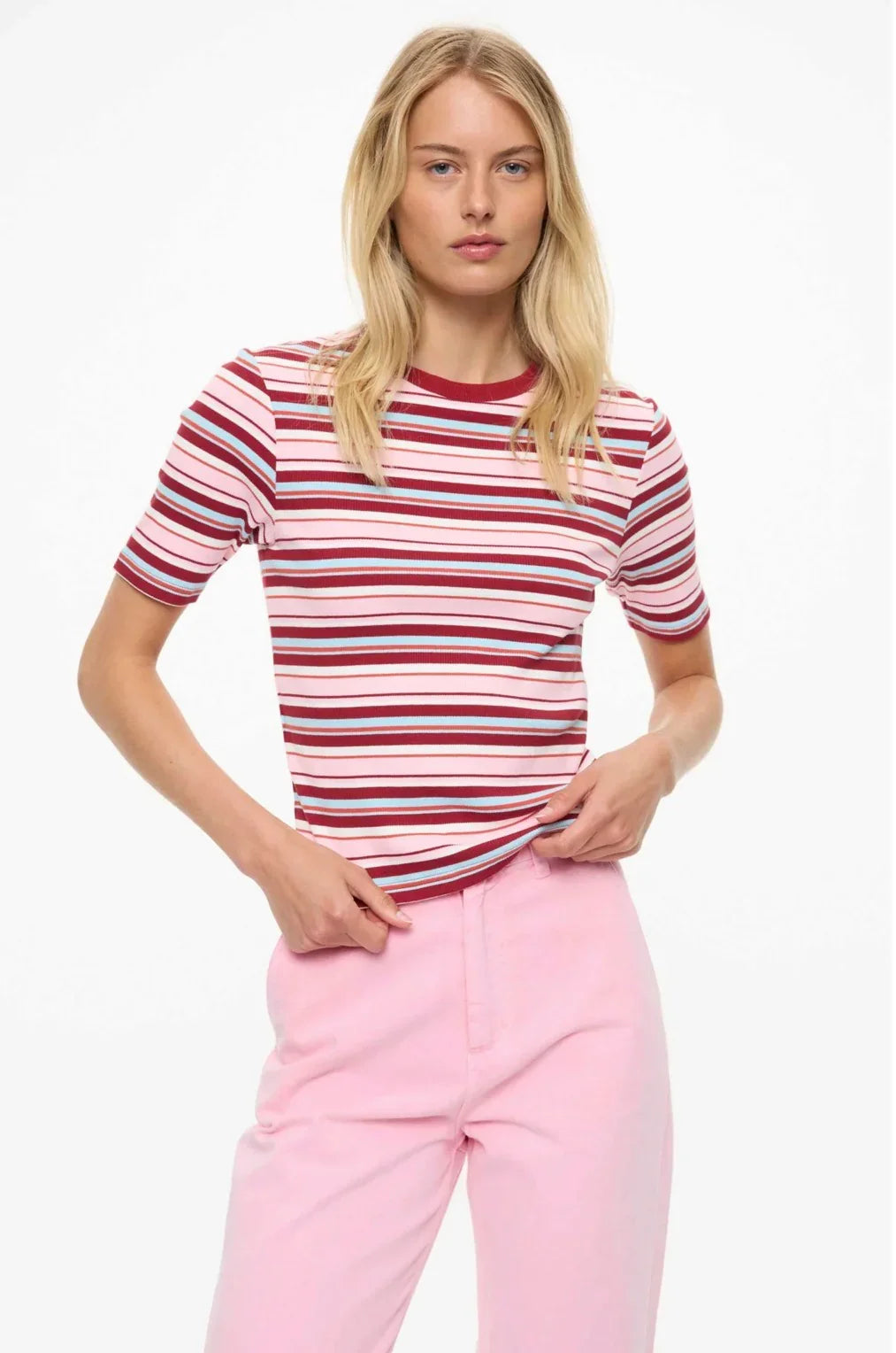 Woman modeling striped short sleeve top with pink pants, women's fashion outfit