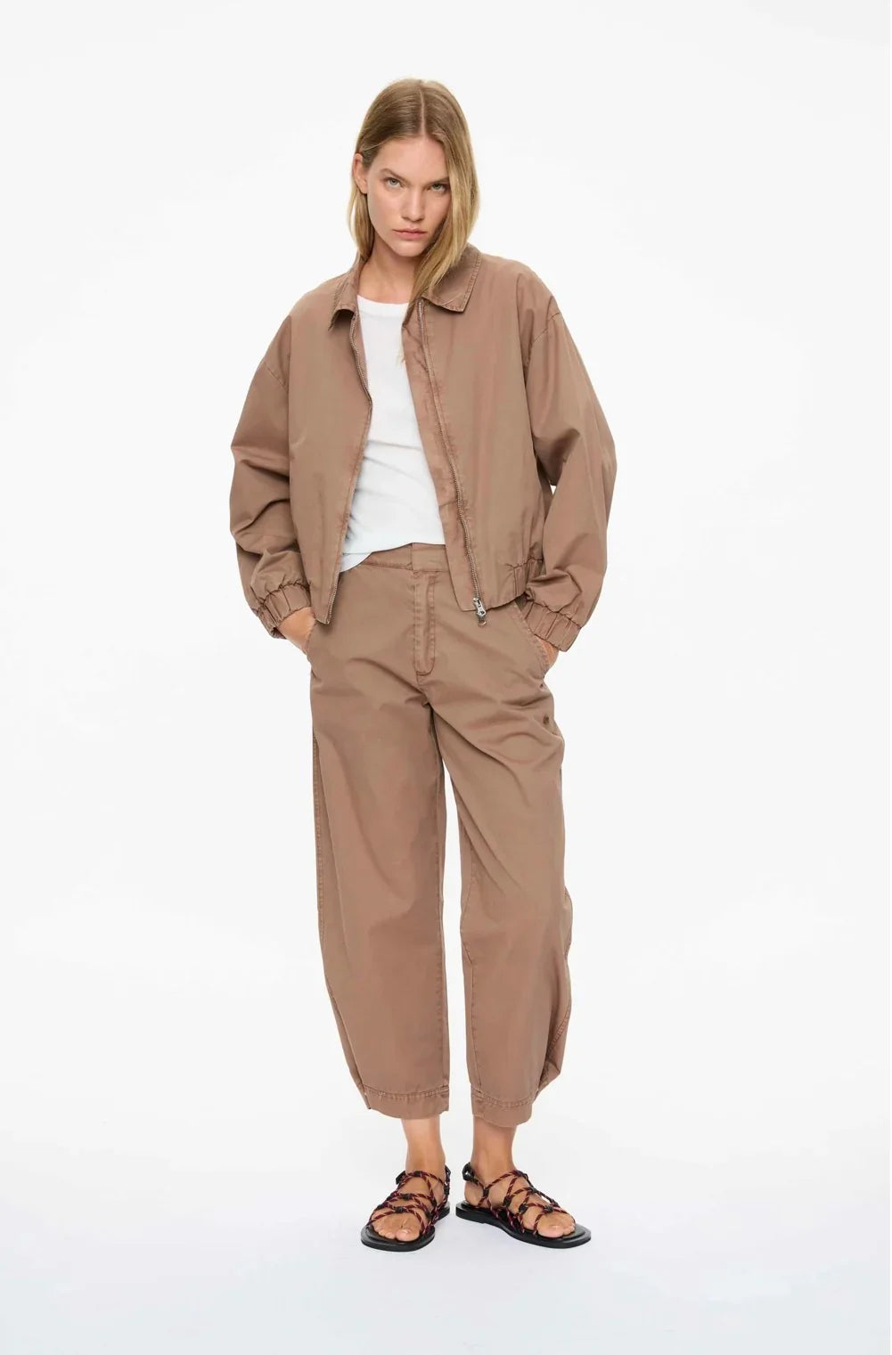 Women's beige bomber jacket and matching pants with strappy sandals, casual fashion outfit