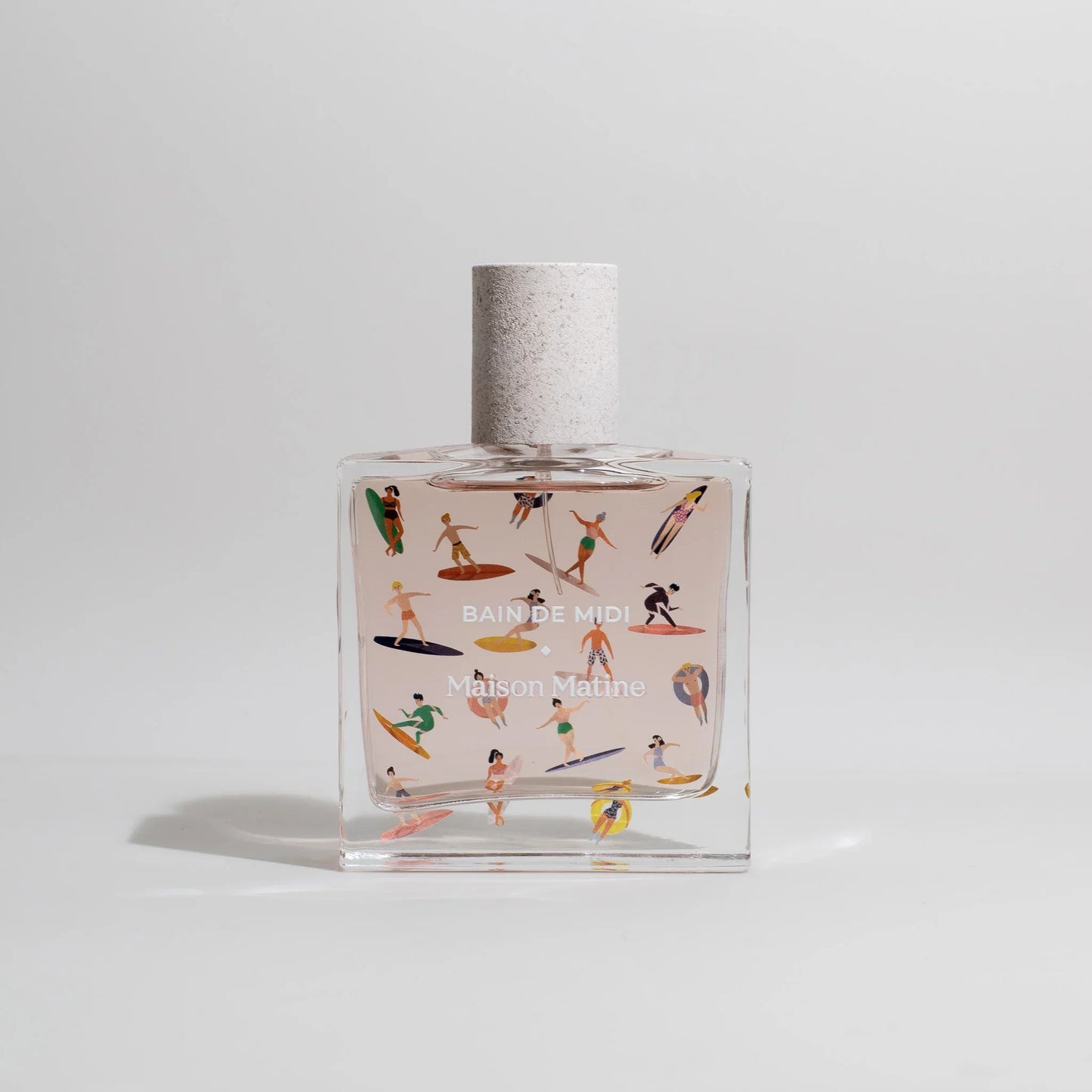 Bain de Midi Maison Matine perfume bottle with colorful surfers, beach vibe, clear glass, textured cap