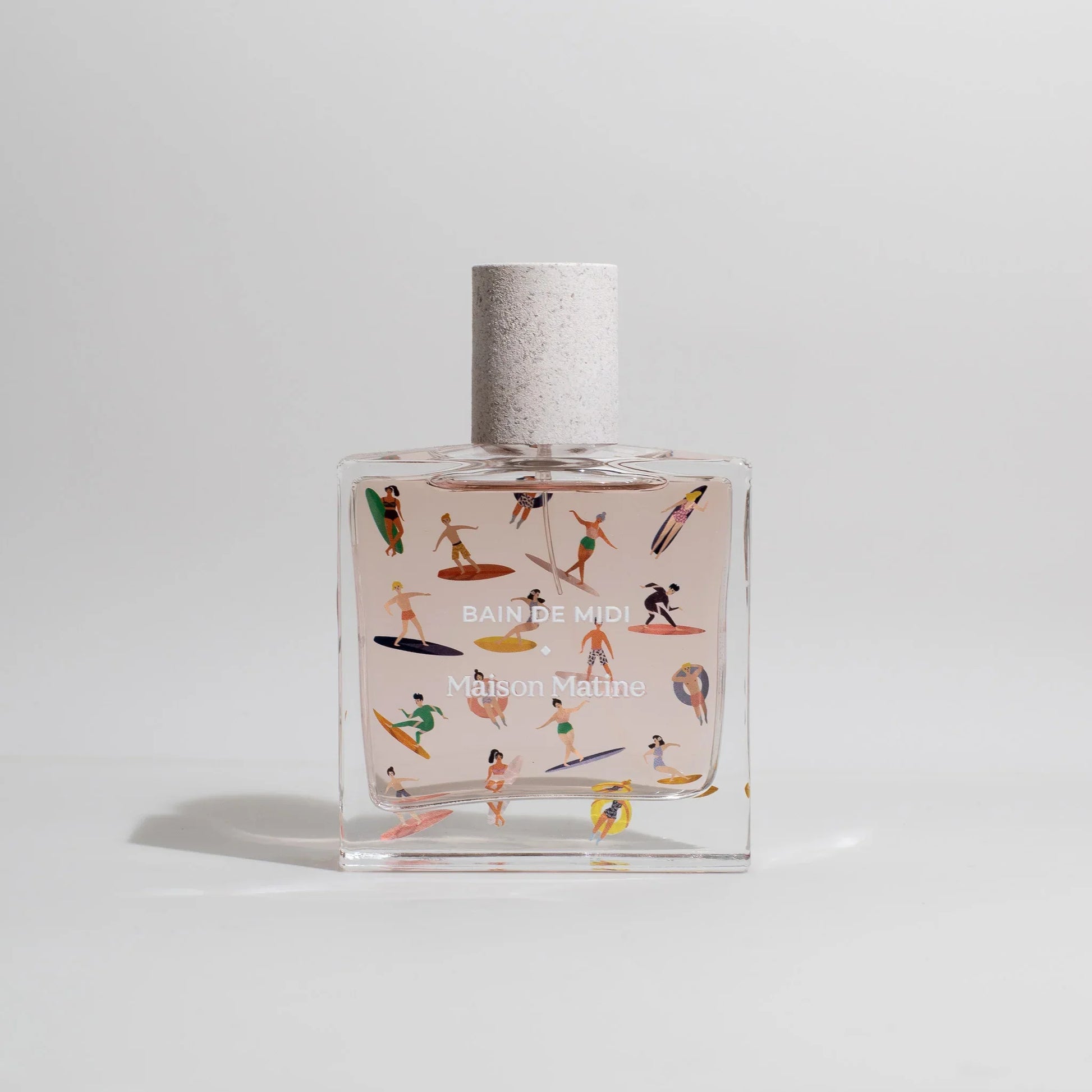 Bain de Midi Maison Matine perfume bottle with colorful surfers, beach vibe, clear glass, textured cap