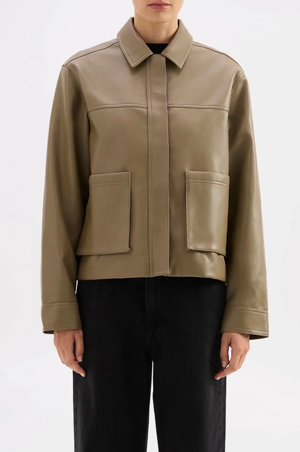 Olive green faux leather jacket with collar and front pockets, styled with black pants