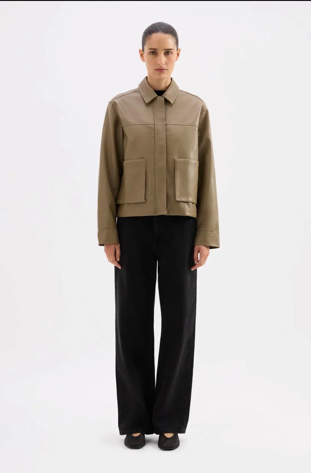 Olive leather jacket with front pockets, paired with black wide-leg pants for modern women's fashion.