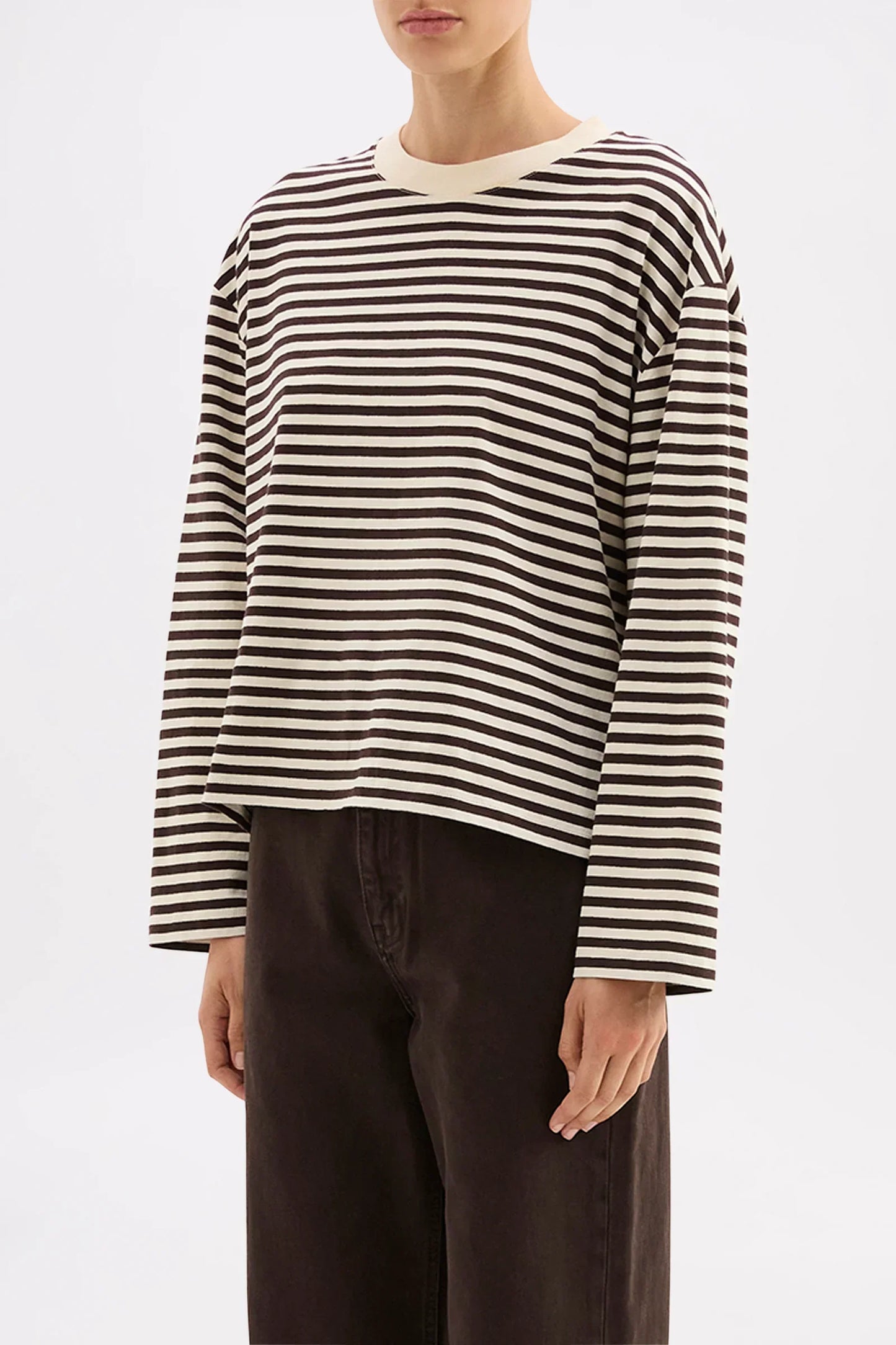 Women's striped long sleeve top with relaxed fit, paired with dark wide-leg pants for casual style
