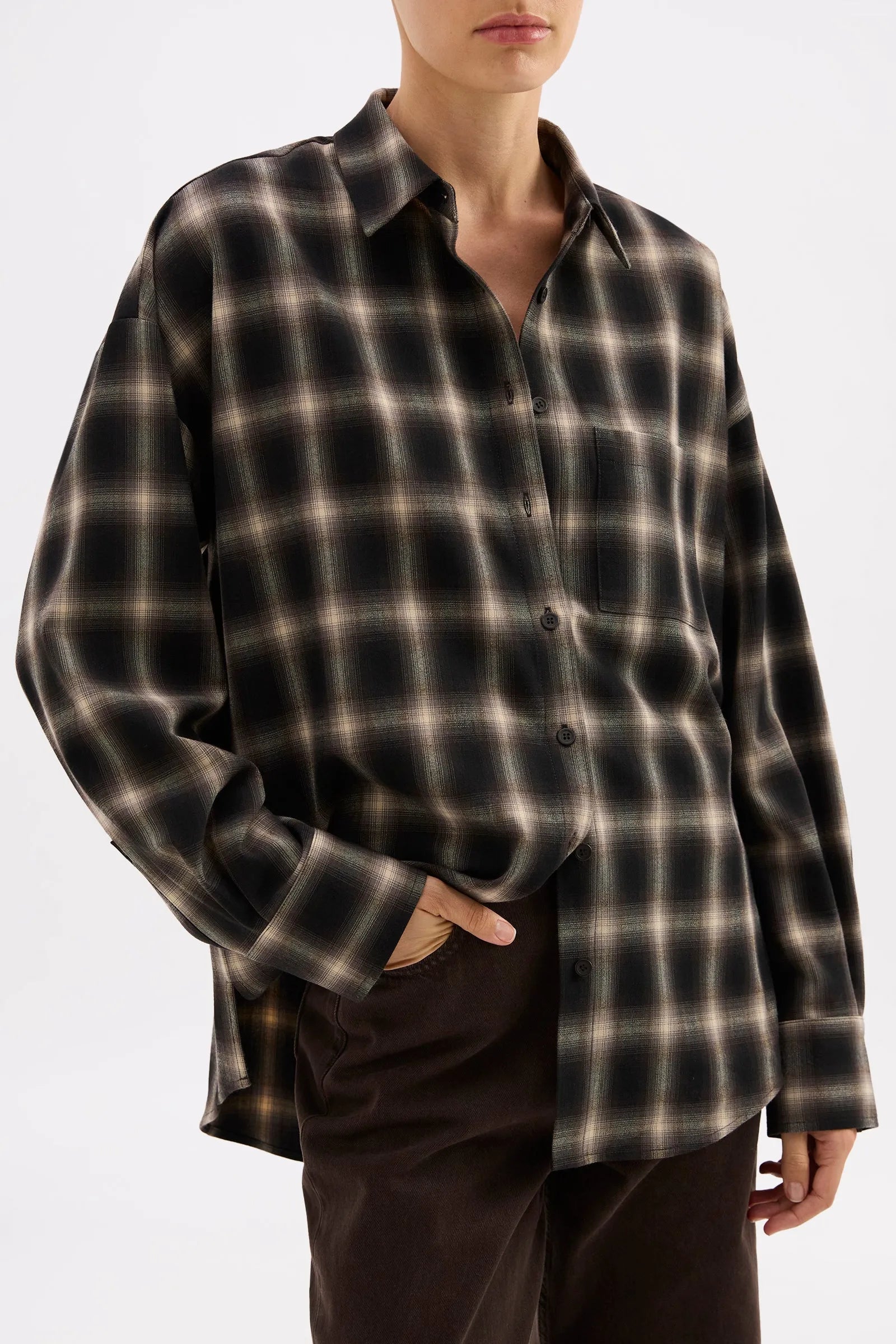 Oversized black and beige plaid button-up shirt with chest pocket, styled for modern women's fashion